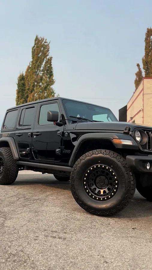 Black Jeep Wrangler on matte black off-road wheels