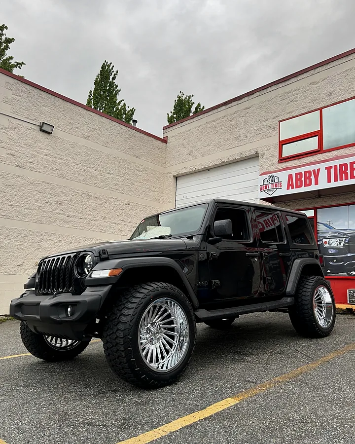 Black Jeep Wrangler on chrome wheels at the shop
