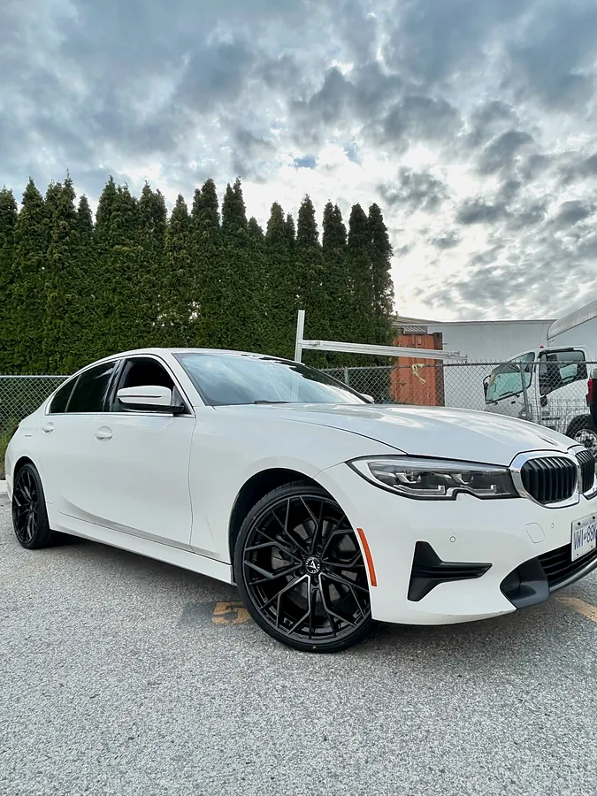 White BMW sedan on gloss black wheels