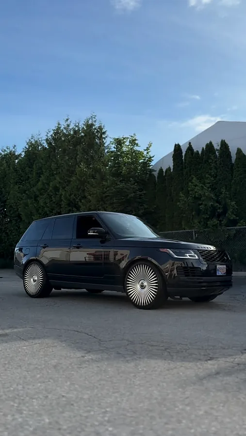 Black Range Rover on dark multi-spoke wheels